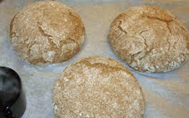 Three oat breads on a table.